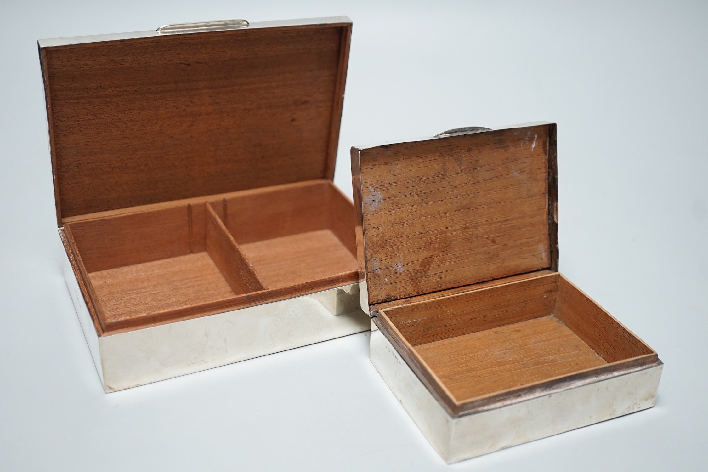 A modern part engine tuned silver mounted cigarette box, 17cm and one other smaller silver mounted cigarette box.